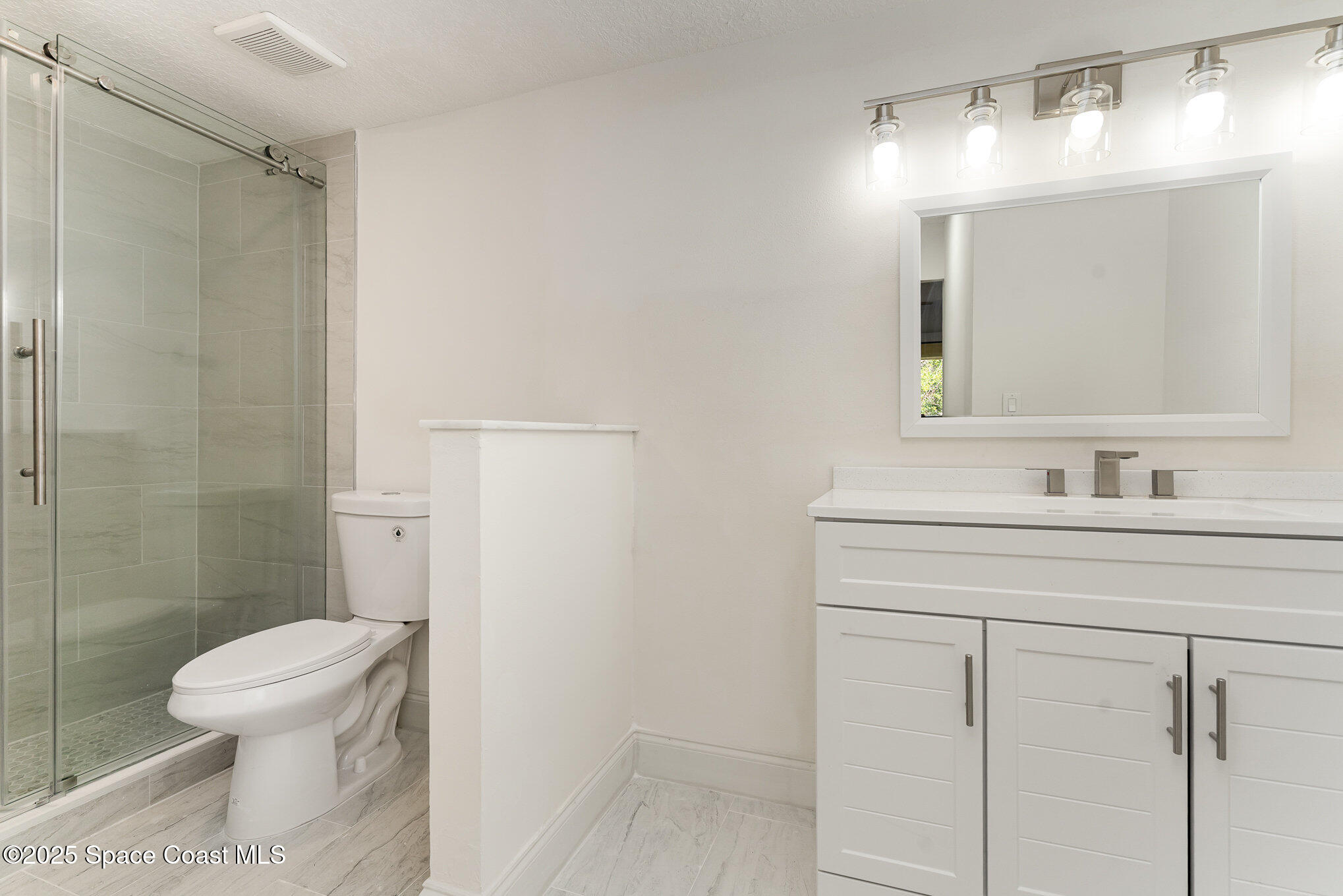 3444 Partridge Court Melbourne, FL 32935 - Photo 24 of 78 a bathroom with a toilet sink and shower