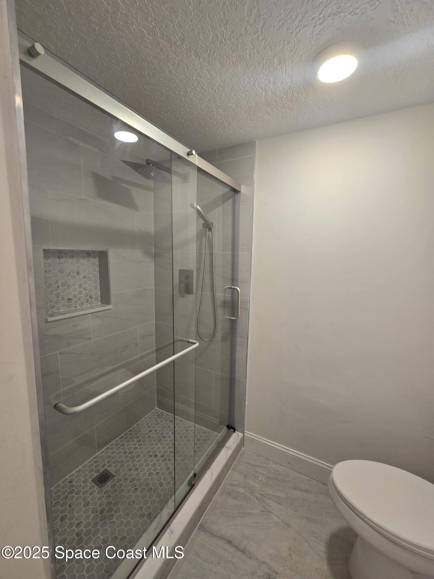 3444 Partridge Court Melbourne, FL 32935 - Photo 36 of 78 a bathroom with a shower a toilet and a sink