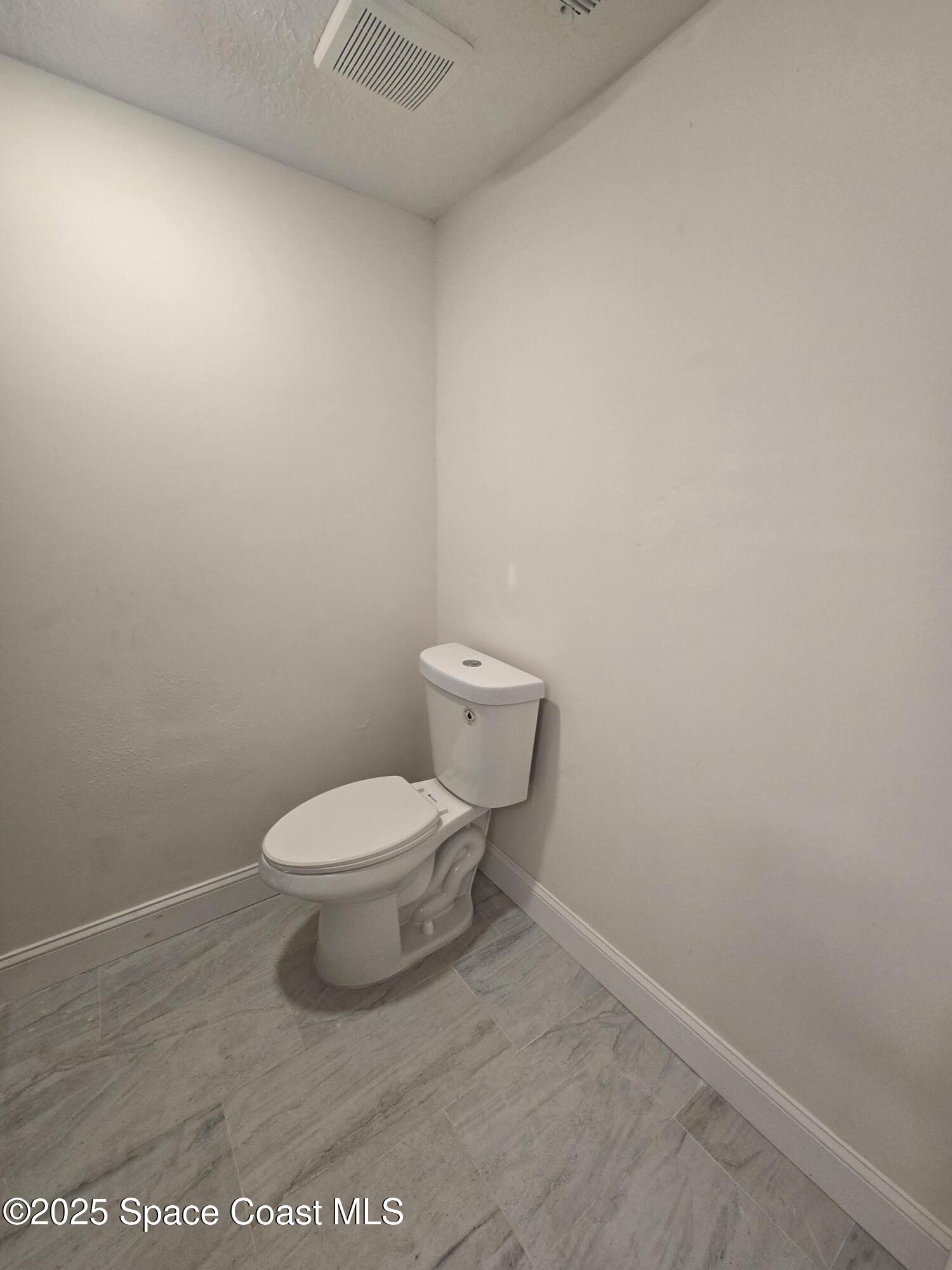3444 Partridge Court Melbourne, FL 32935 - Photo 38 of 78 a white toilet sitting next to a white wall