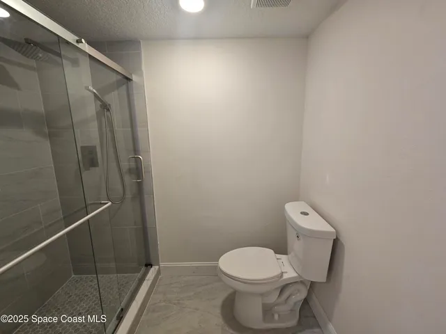 a white toilet next to a bathroom sink