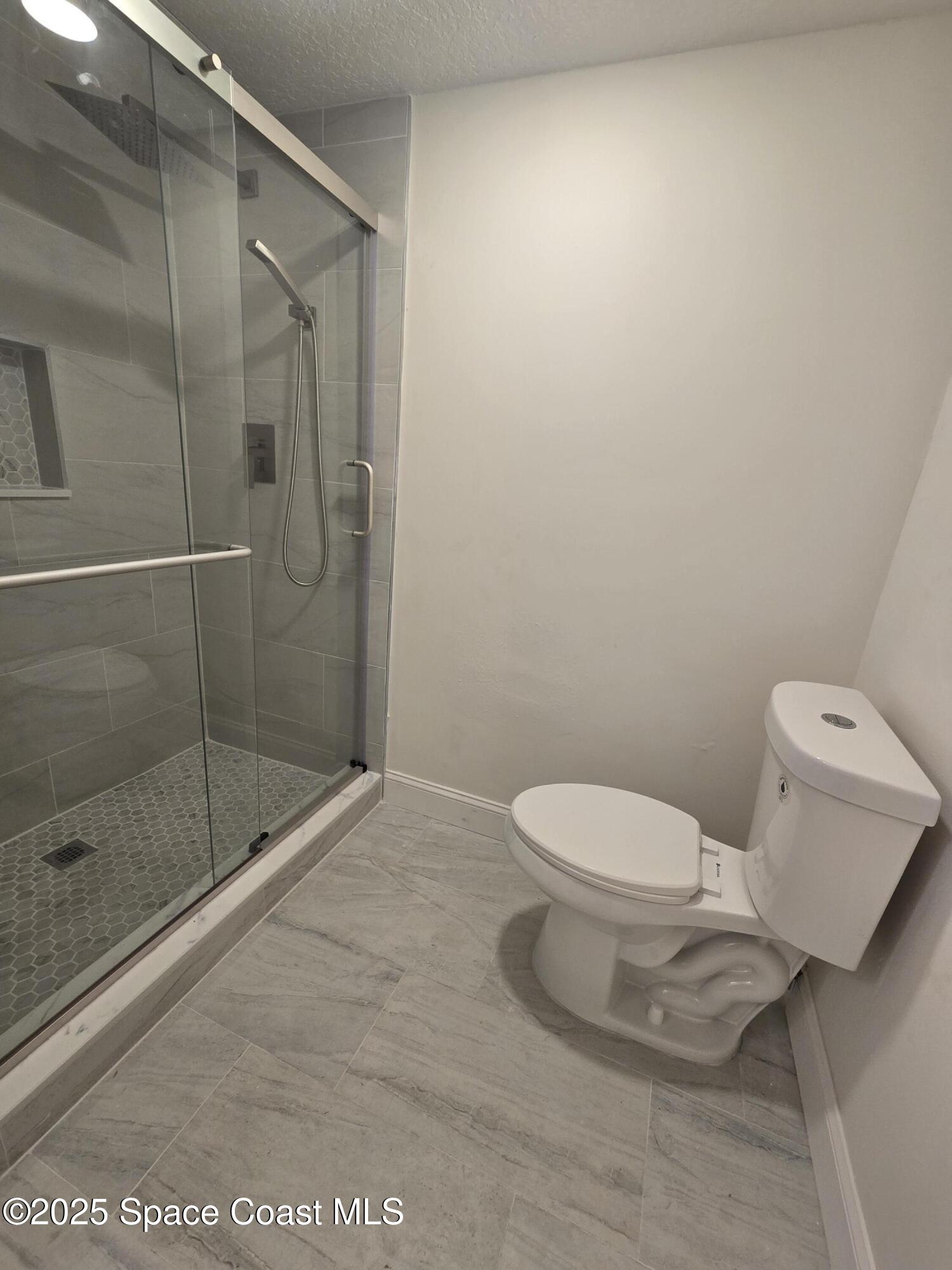 3444 Partridge Court Melbourne, FL 32935 - Photo 40 of 78 a white toilet sitting next to a bath tub