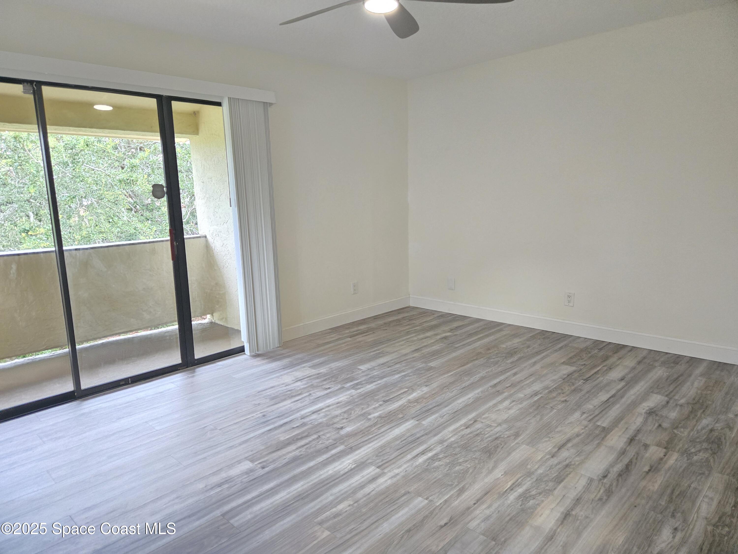 3444 Partridge Court Melbourne, FL 32935 - Photo 60 of 78 wooden floor in an empty room with a window