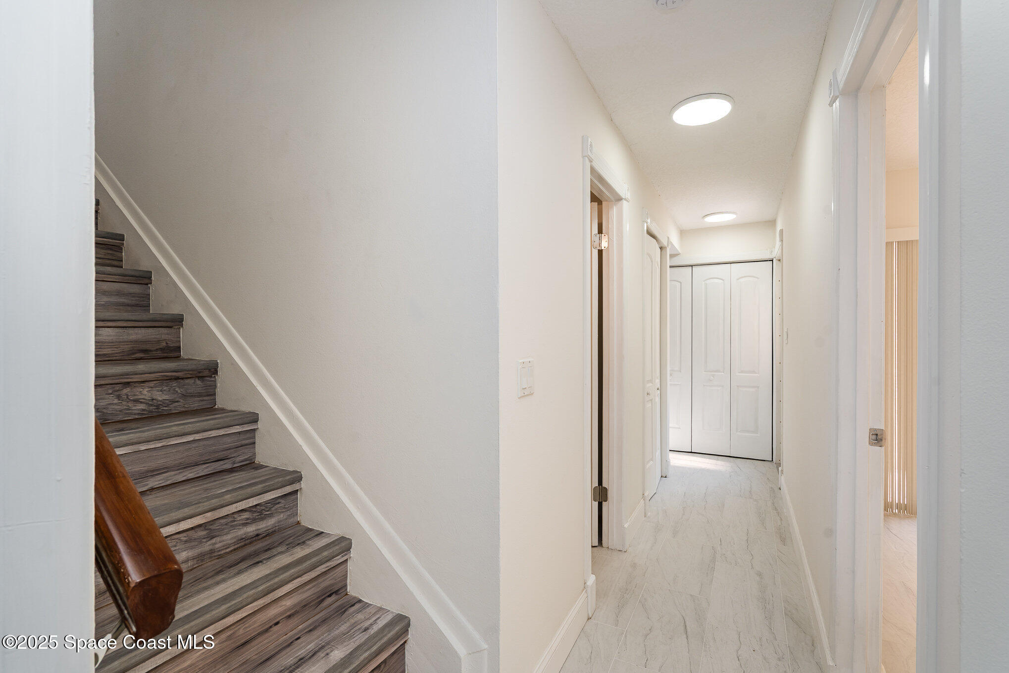 3444 Partridge Court Melbourne, FL 32935 - Photo 6 of 78 a view of a hallway with wooden floor and entryway