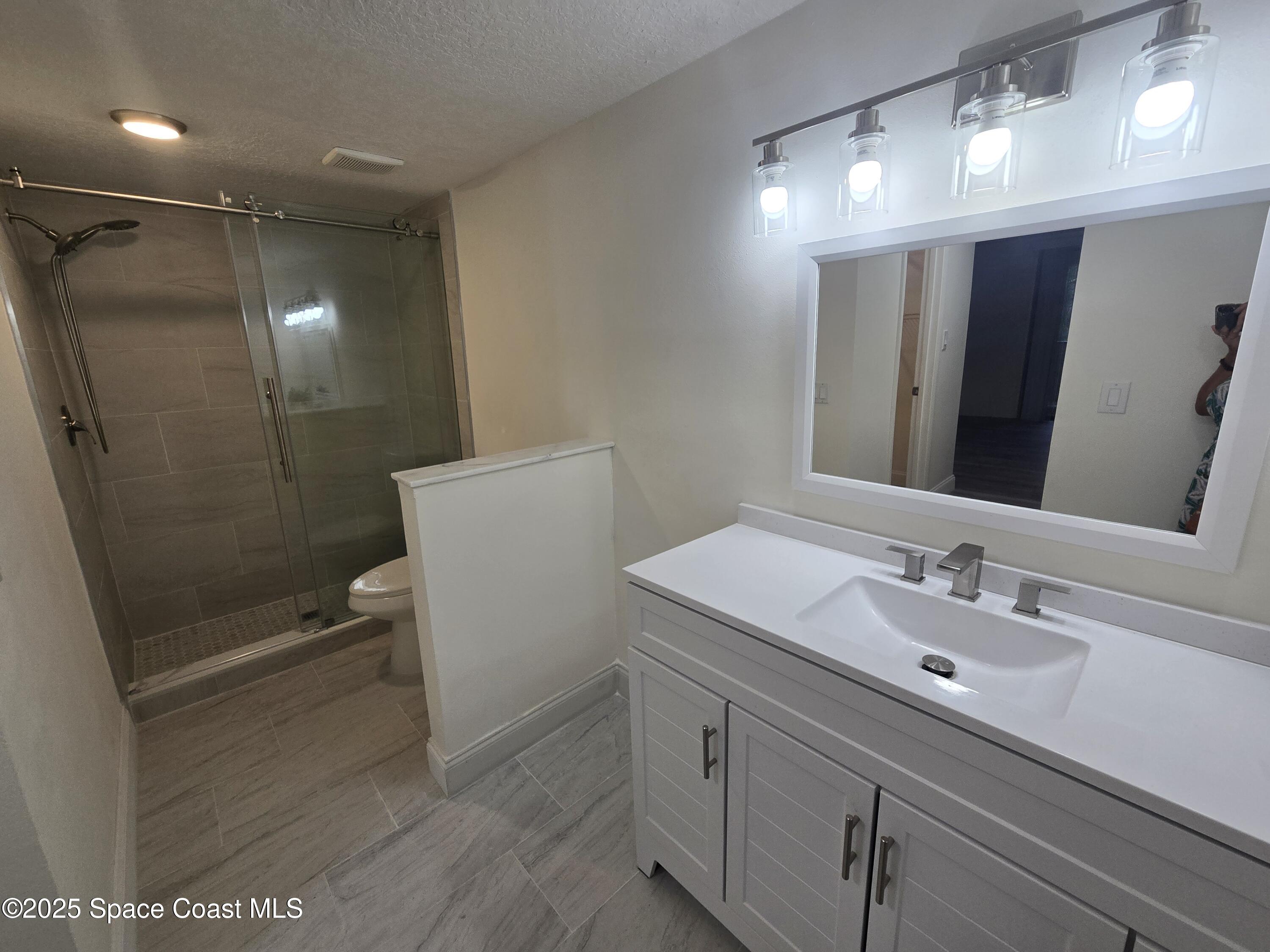 3444 Partridge Court Melbourne, FL 32935 - Photo 68 of 78 a bathroom with a sink a toilet and shower