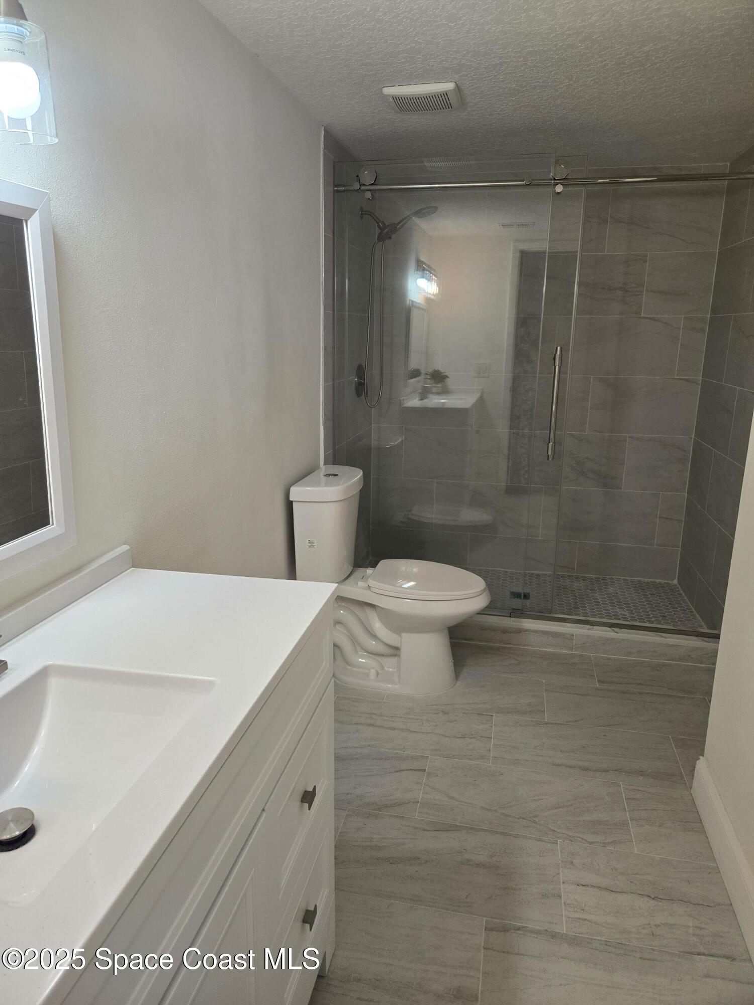 3444 Partridge Court Melbourne, FL 32935 - Photo 71 of 78 a bathroom with a sink a toilet and shower