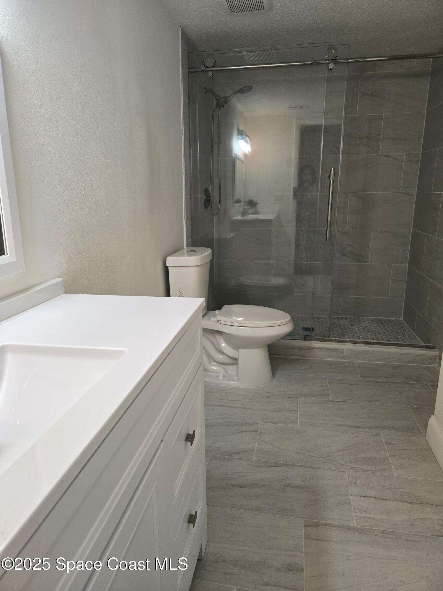 3444 Partridge Court Melbourne, FL 32935 - Photo 72 of 78 a bathroom with a sink a toilet and shower