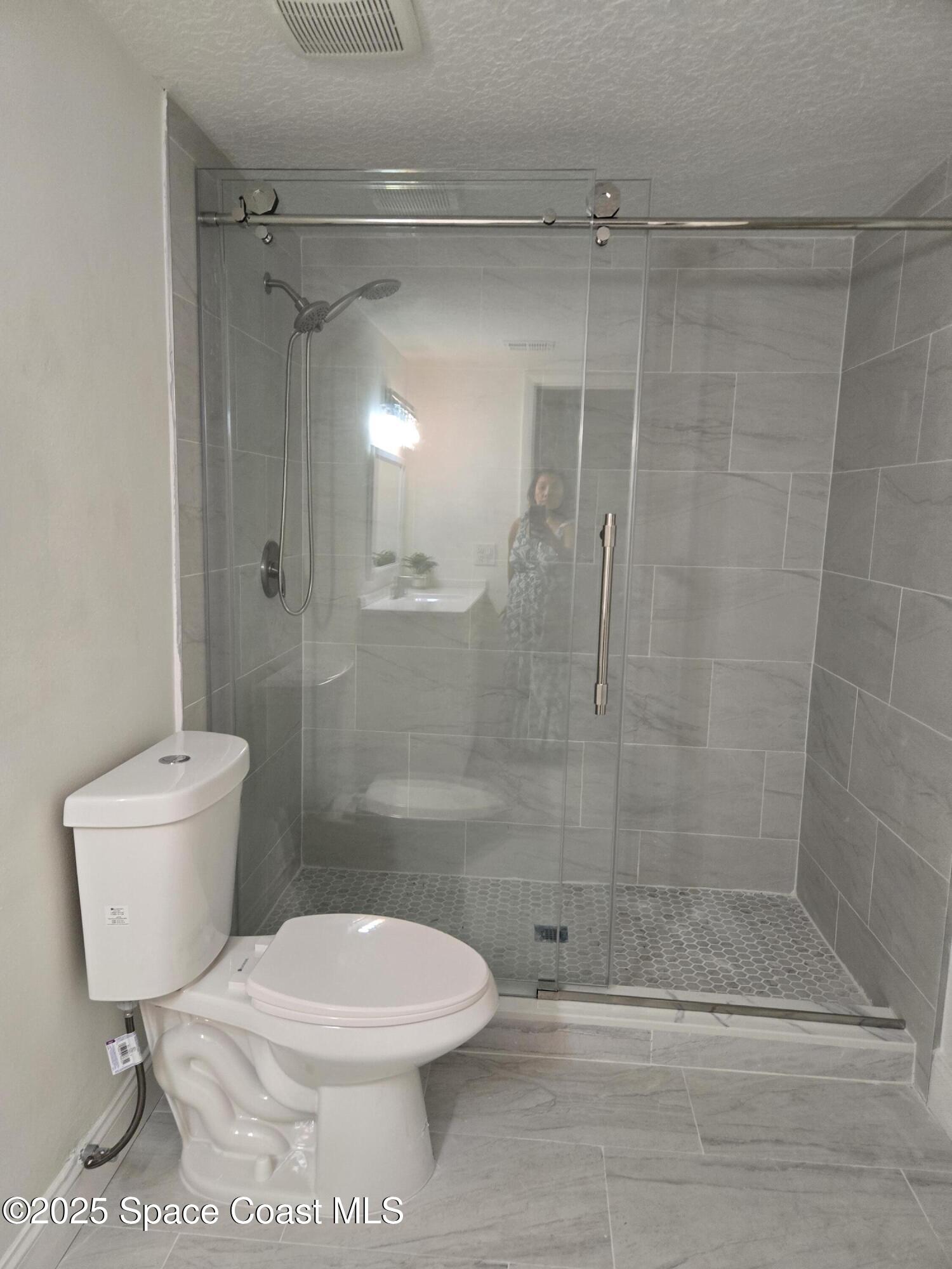 3444 Partridge Court Melbourne, FL 32935 - Photo 74 of 78 a bathroom with a toilet and a shower