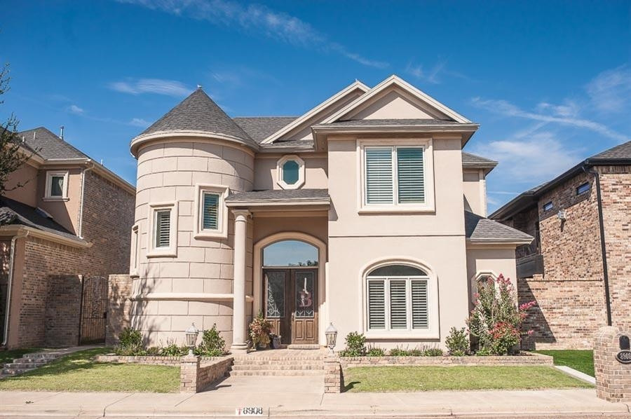 a front view of a house with a yard