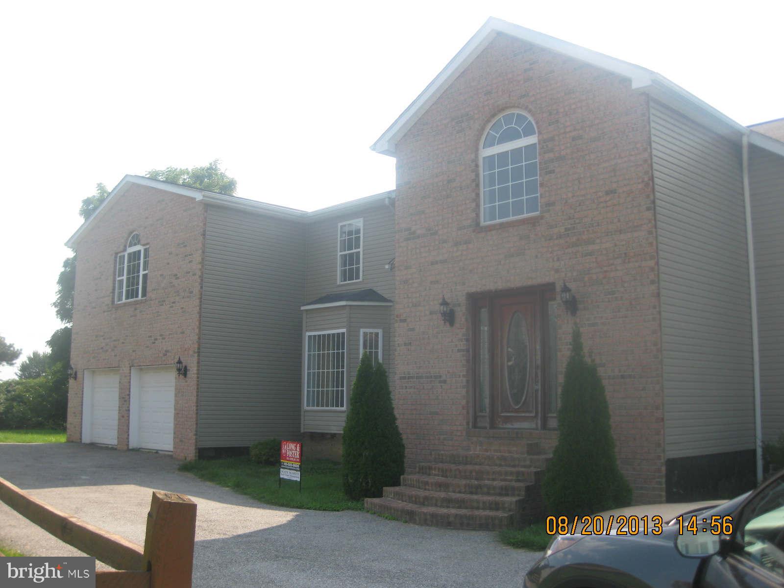 8673 Winands Road Randallstown, MD 21133 - Photo 1 of 12 a front view of a house with a yard