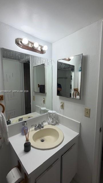 8002 Southwest 149th Avenue, Unit B201 Miami, FL 33193 - Photo 11 of 13 a bathroom with a sink and a mirror