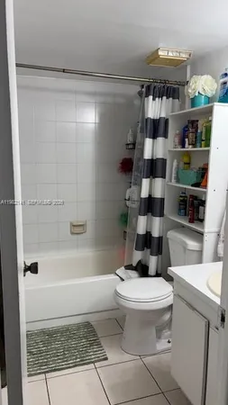 a kitchen with a refrigerator and cabinets