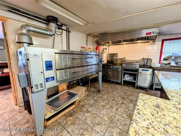 a kitchen with stainless steel appliances granite countertop a sink and a stove