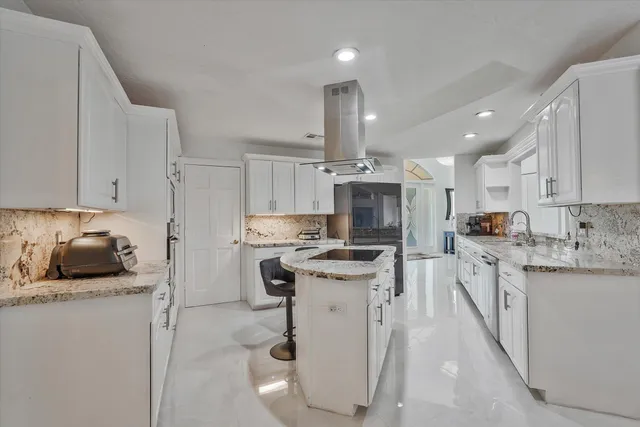 a kitchen that has a lot of cabinets in it and appliances