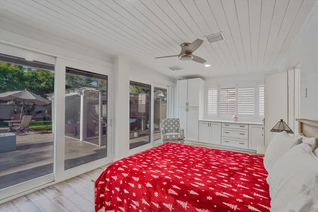 a bedroom with a large bed and a large window