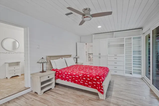 a bedroom with a bed and a chandelier