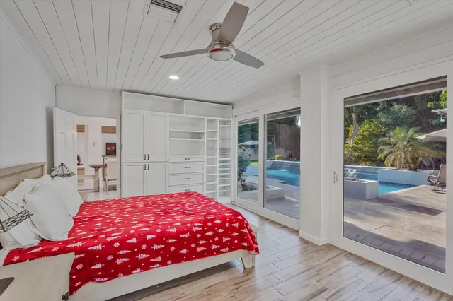 a bedroom with a large bed and a window