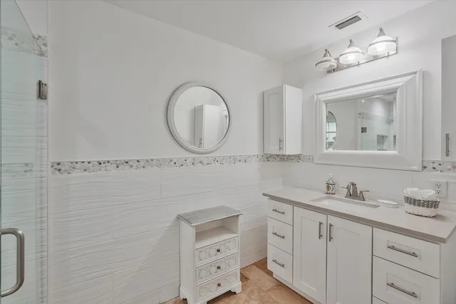 a bathroom with a double vanity sink mirror and