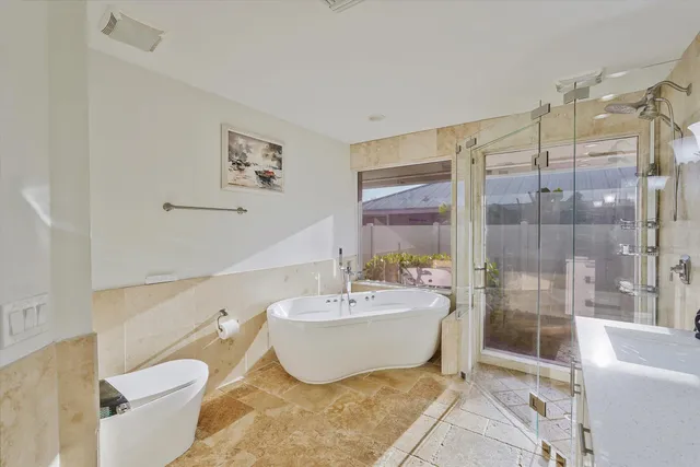 a spacious bathroom with a bathtub and shower