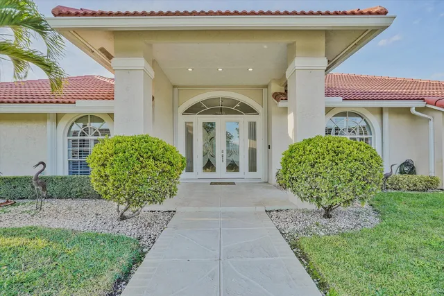 a front view of a house with garden