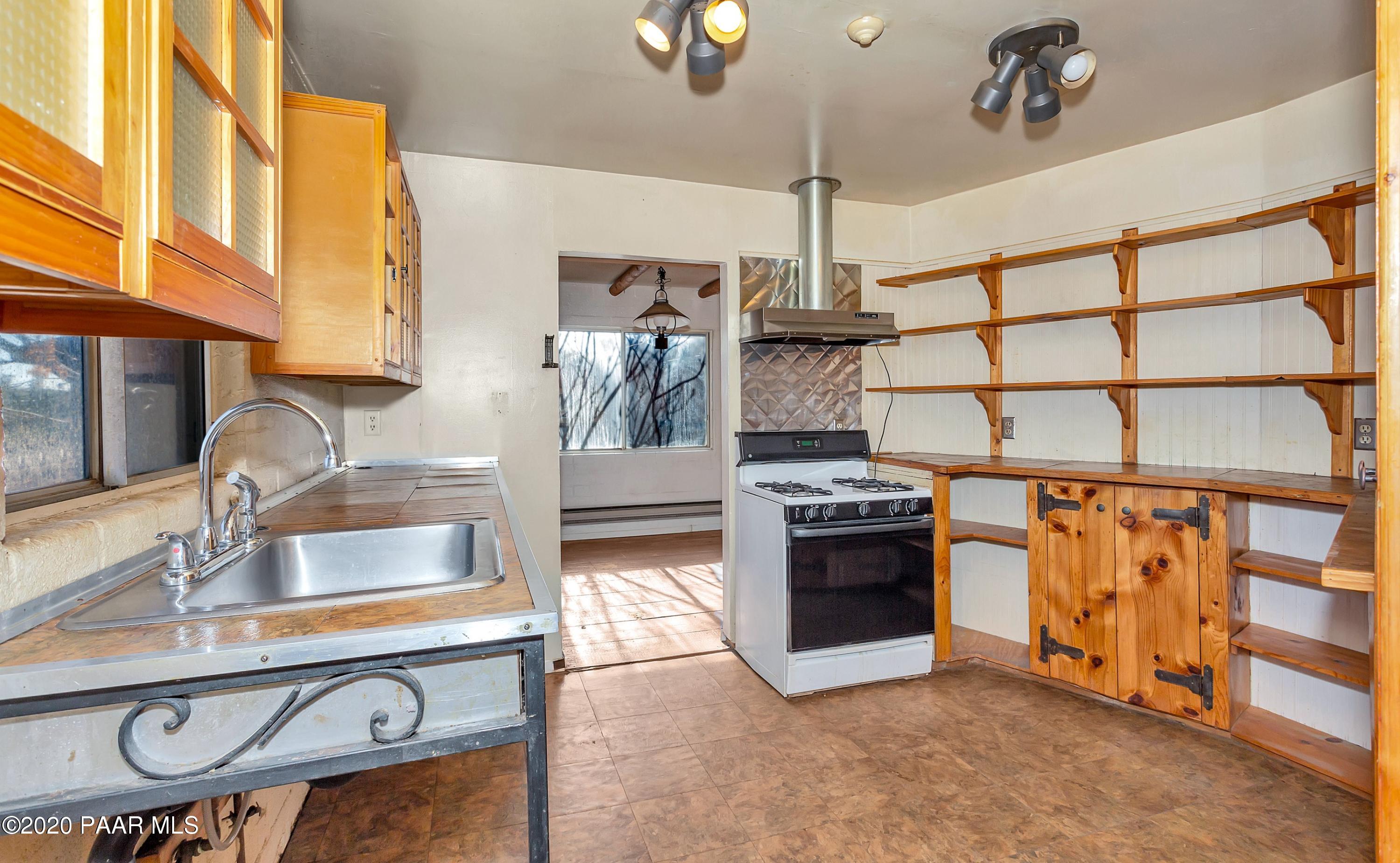 2571 North Reed Road Chino Valley, AZ 86323 - Photo 4 of 25 a kitchen with stainless steel appliances granite countertop a sink and a stove next to a window