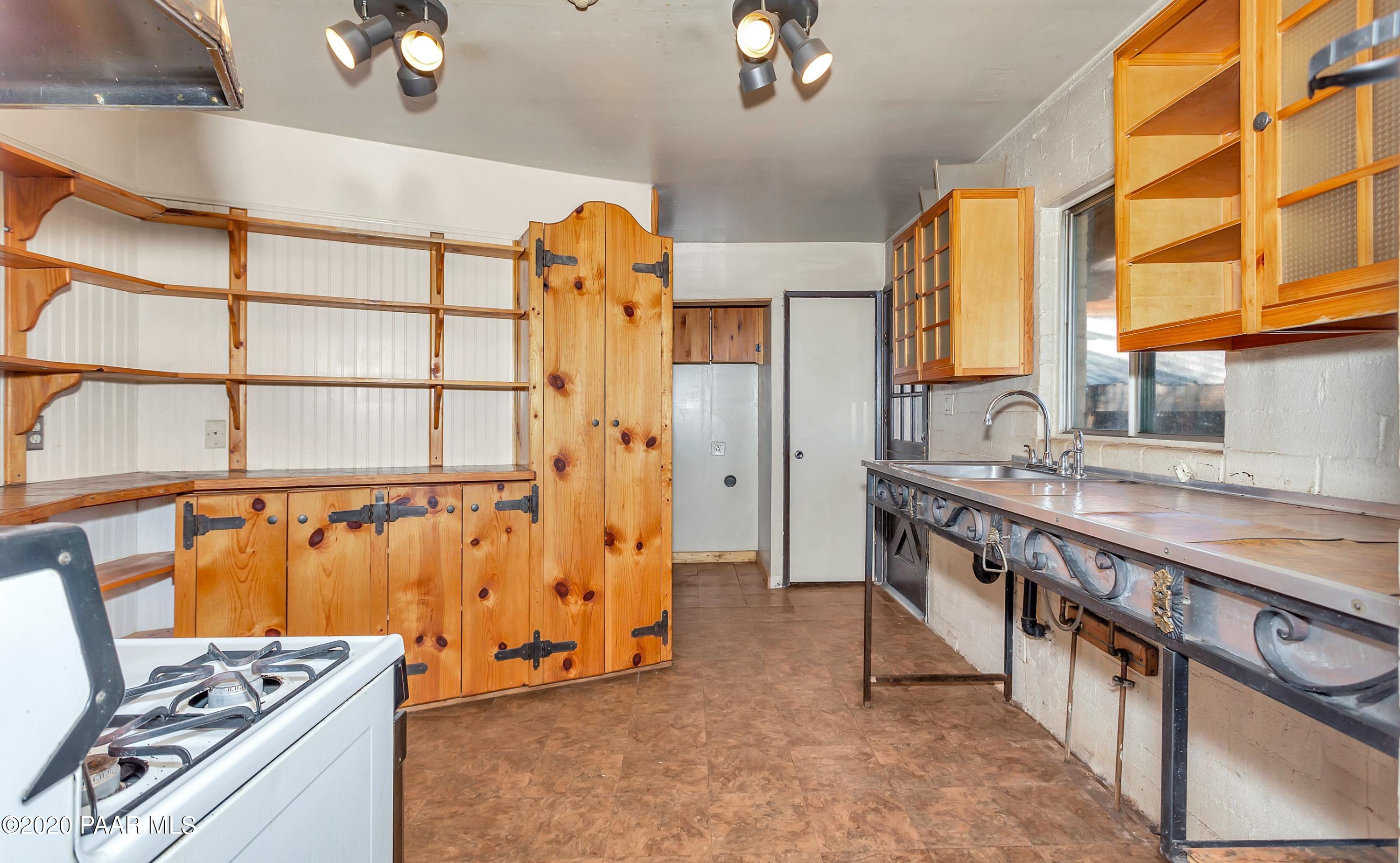 2571 North Reed Road Chino Valley, AZ 86323 - Photo 5 of 25 a kitchen with stainless steel appliances granite countertop a stove a sink and a refrigerator