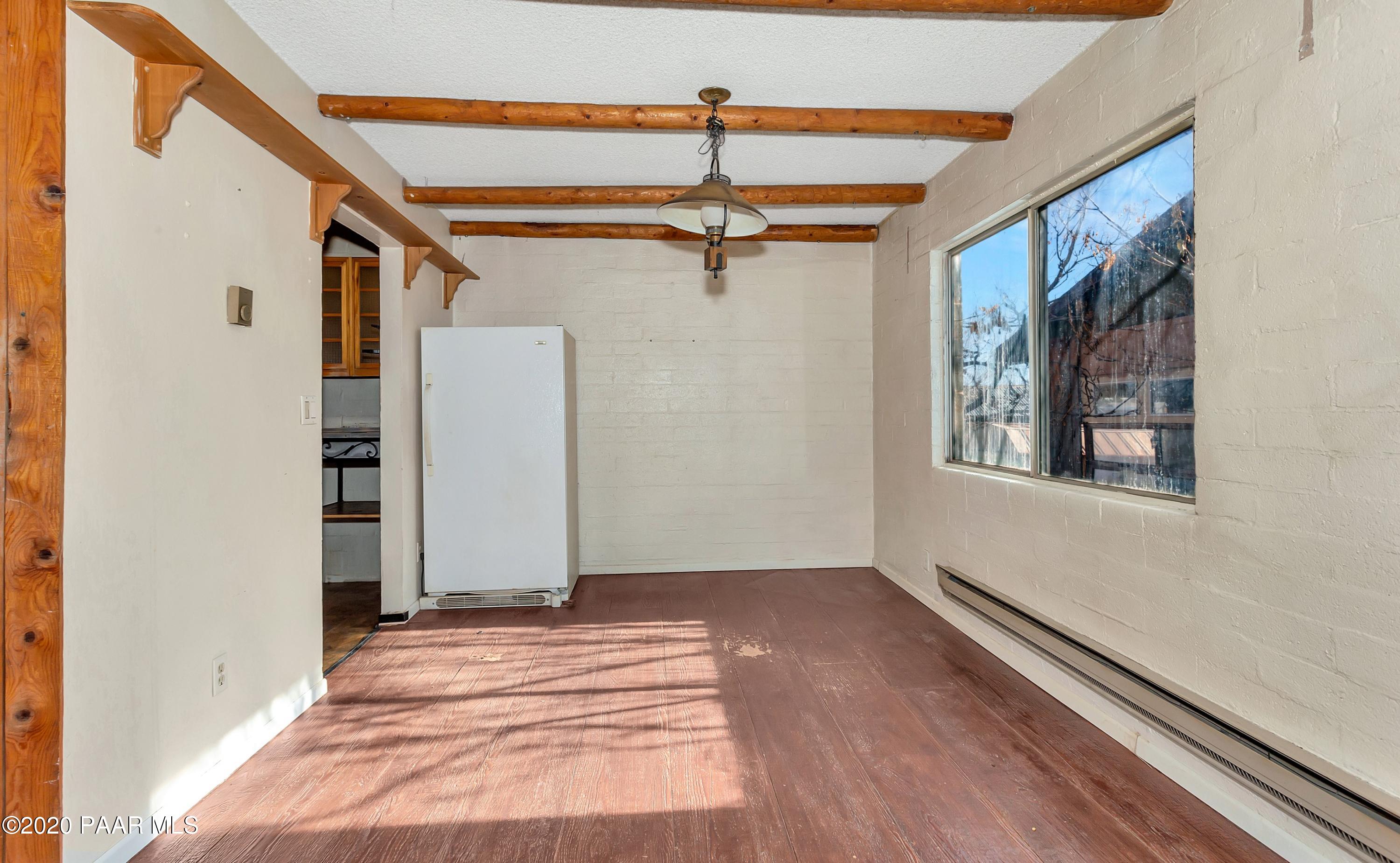 2571 North Reed Road Chino Valley, AZ 86323 - Photo 6 of 25 a view of a hallway with a window and a chandelier