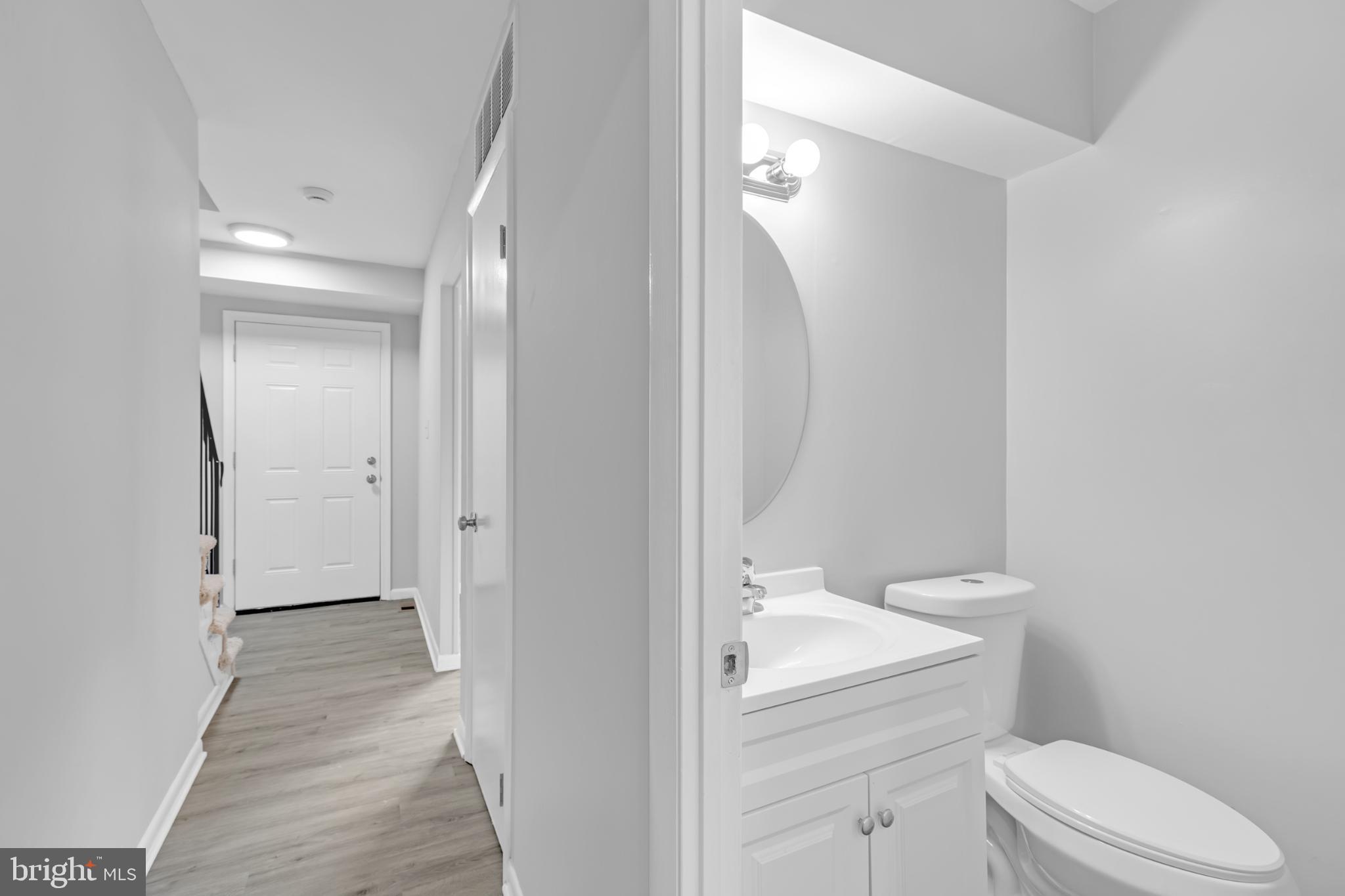 7403 Larne Lane Lorton, VA 22079 - Photo 11 of 31 a bathroom with a granite countertop toilet and sink