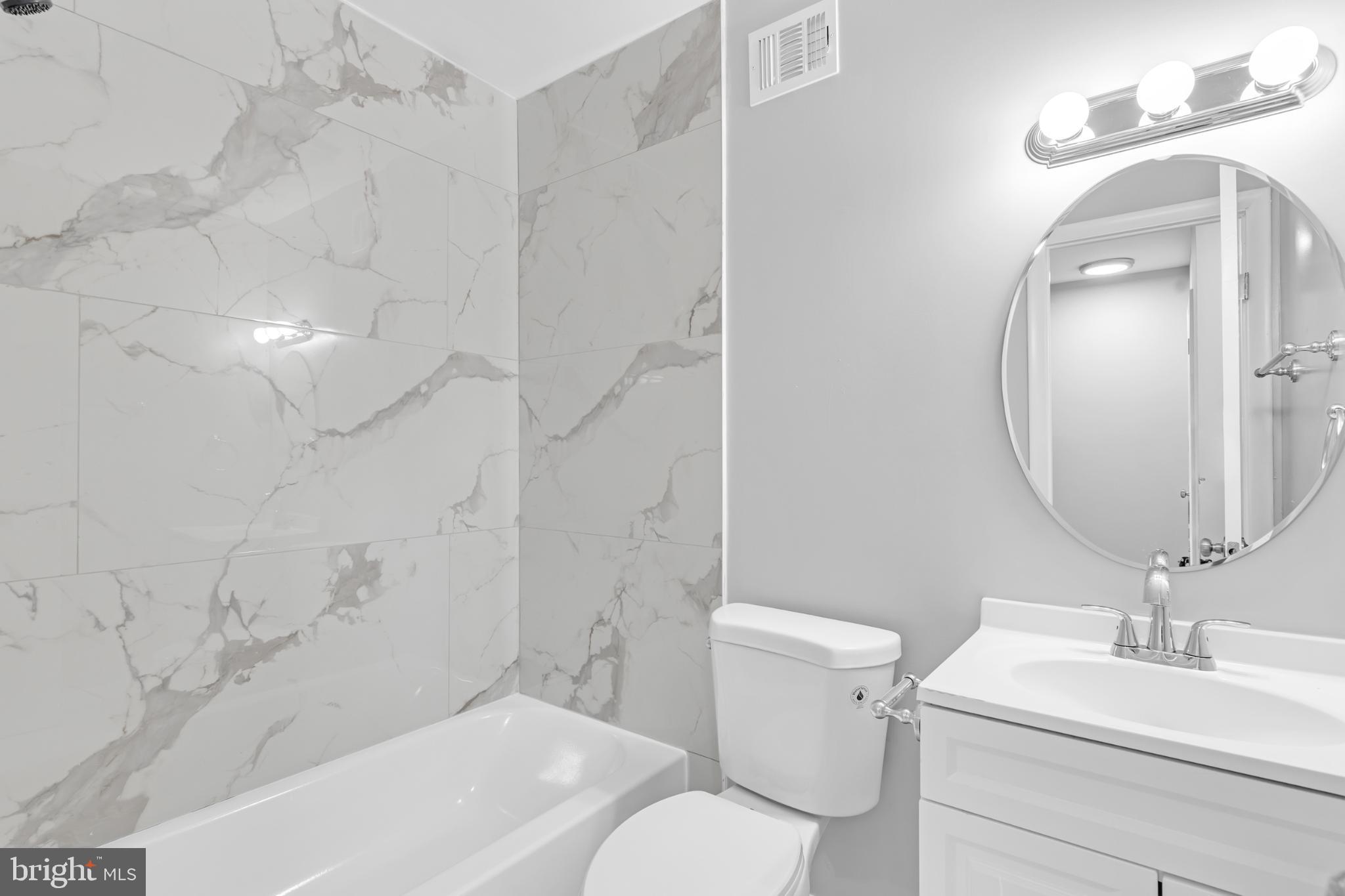 7403 Larne Lane Lorton, VA 22079 - Photo 20 of 31 a bathroom with a sink a toilet and a mirror