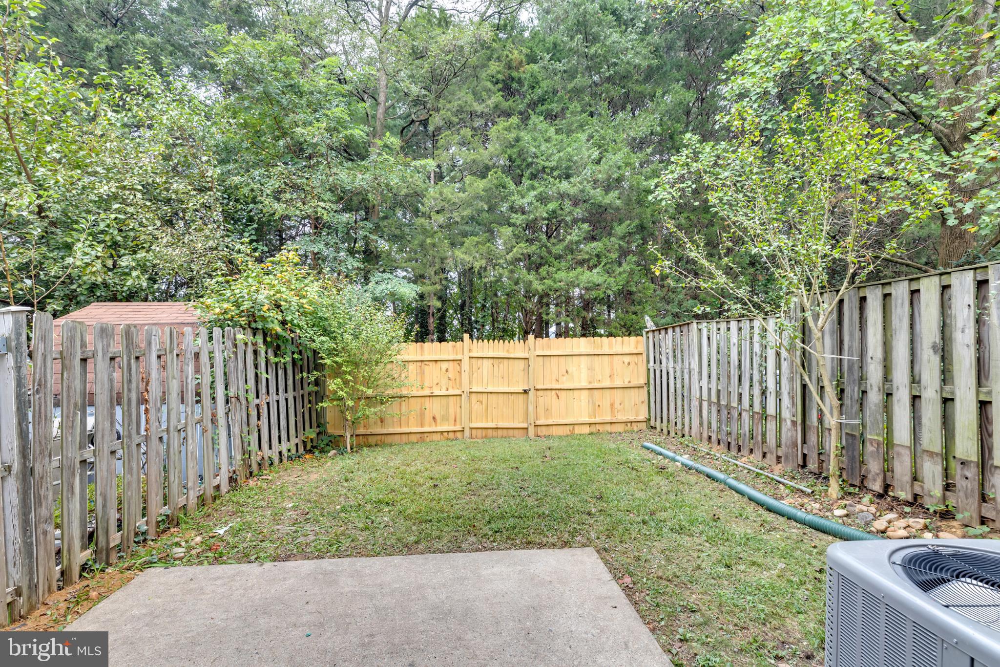 7403 Larne Lane Lorton, VA 22079 - Photo 26 of 31 a view of backyard with wooden fence and trees