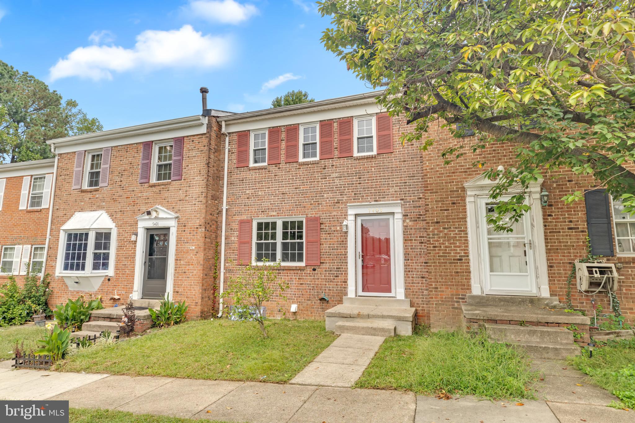 7403 Larne Lane Lorton, VA 22079 - Photo 3 of 31 a front view of a house with a yard