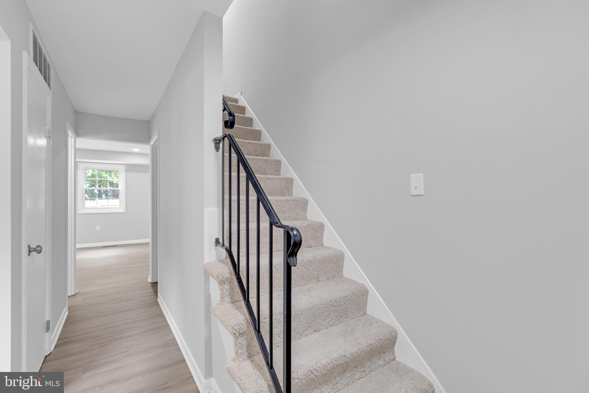 7403 Larne Lane Lorton, VA 22079 - Photo 4 of 31 a view of a hallway with wooden floor and entryway