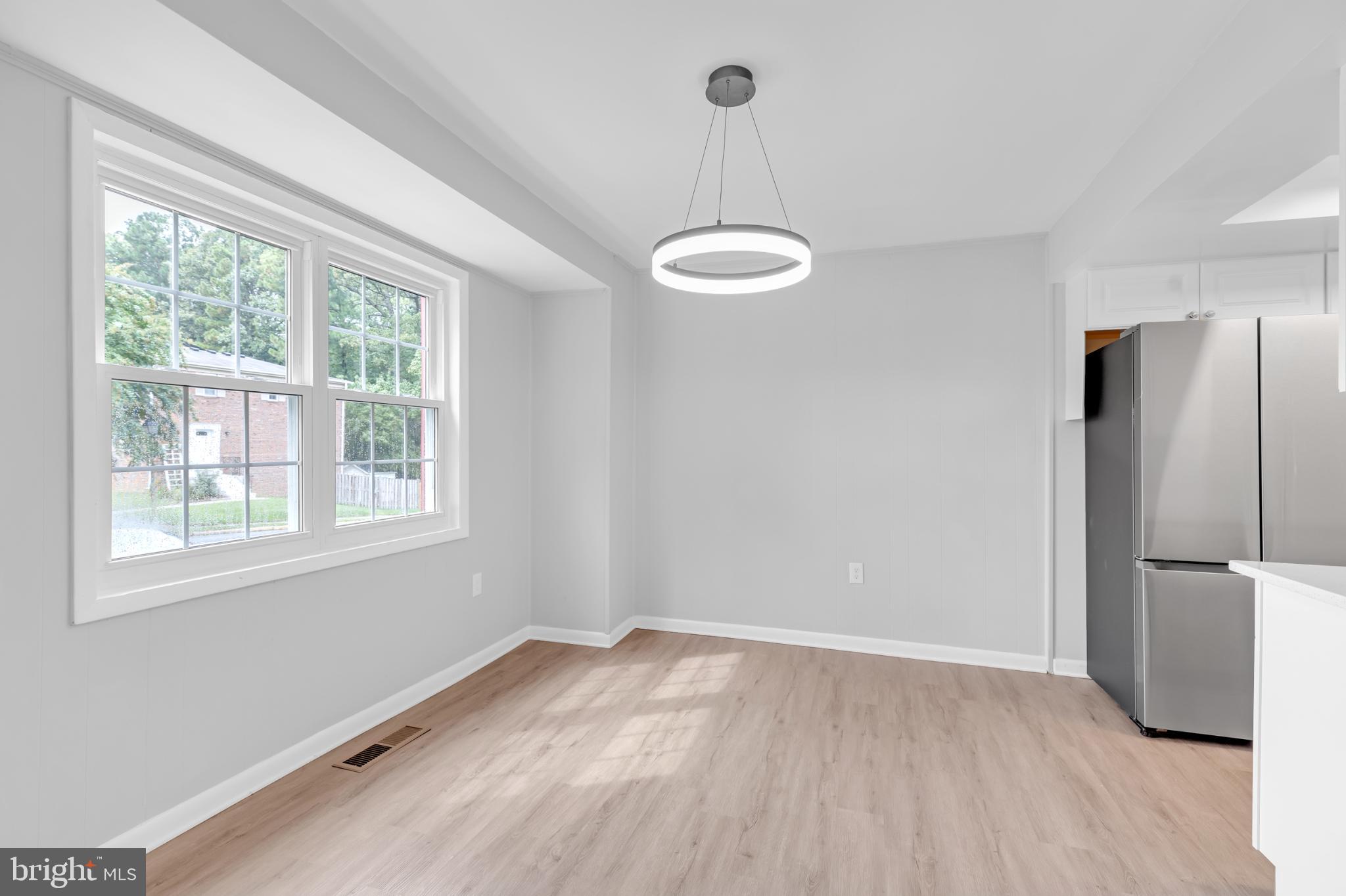 7403 Larne Lane Lorton, VA 22079 - Photo 5 of 31 a view of an empty room with a window and wooden floor