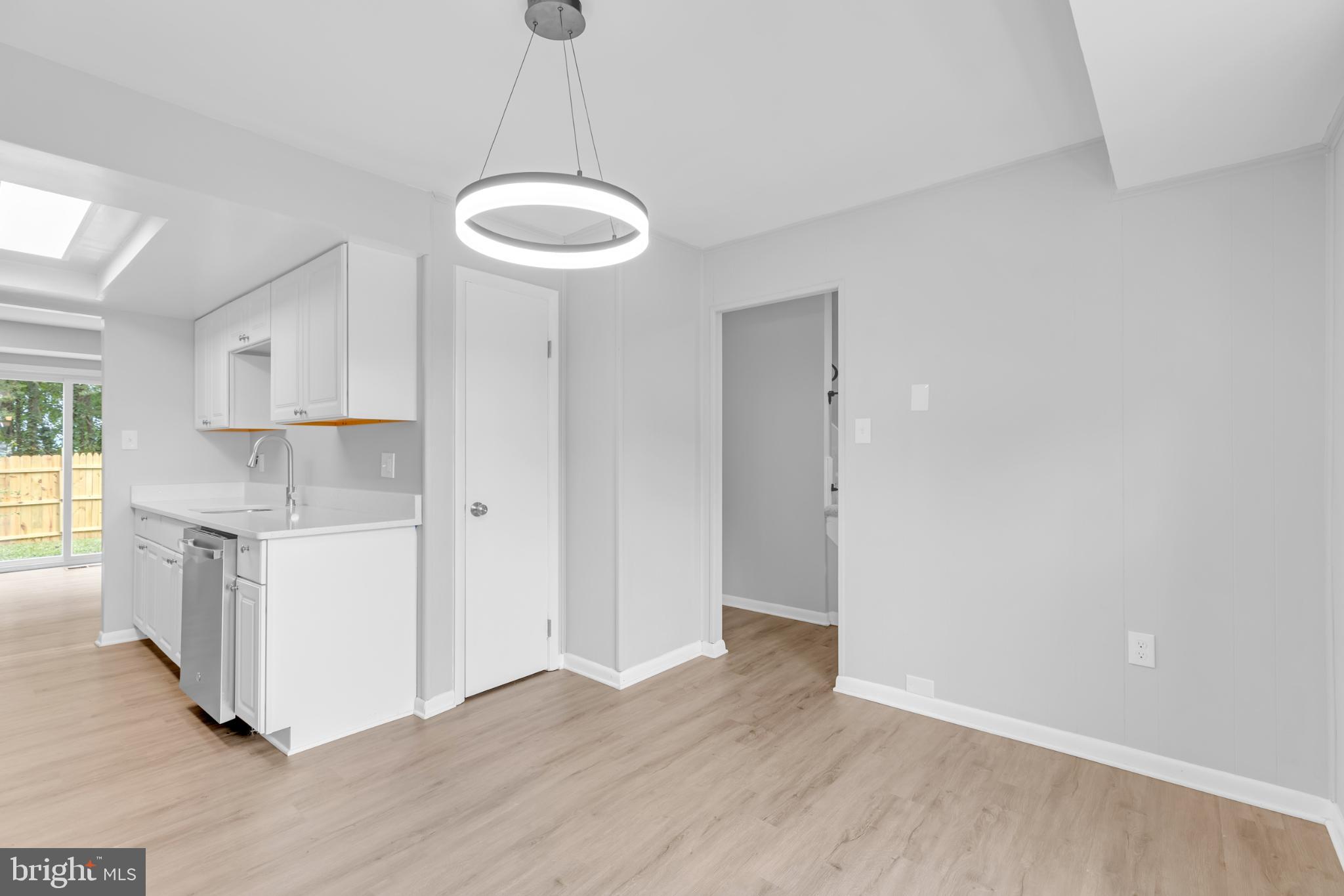 7403 Larne Lane Lorton, VA 22079 - Photo 6 of 31 a view of a kitchen with a sink and dishwasher a refrigerator with wooden floor
