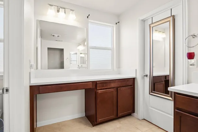 a spacious bathroom with a sink and a mirror