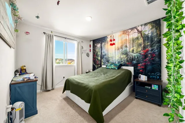 a bedroom with a bed and a window