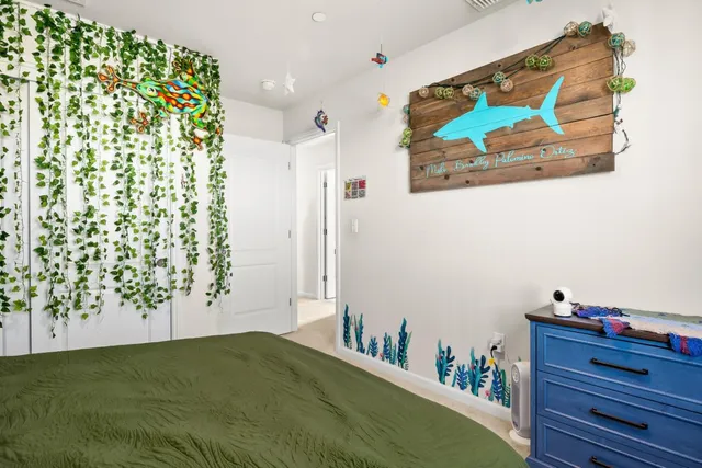 a bedroom with a large bed and a dresser