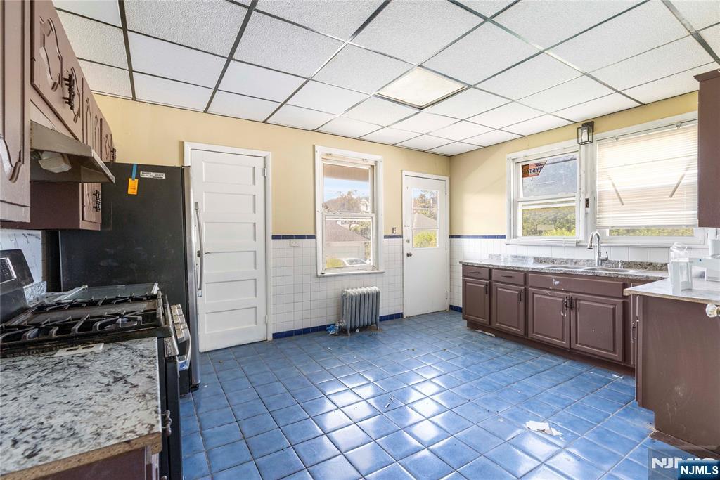 a kitchen with stainless steel appliances granite countertop a sink and cabinets