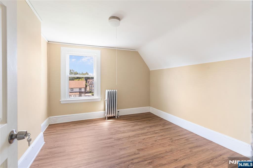 24 Swaine Place, Unit 22 West Orange, NJ 07052 - Photo 11 of 27 an empty room with wooden floor and windows