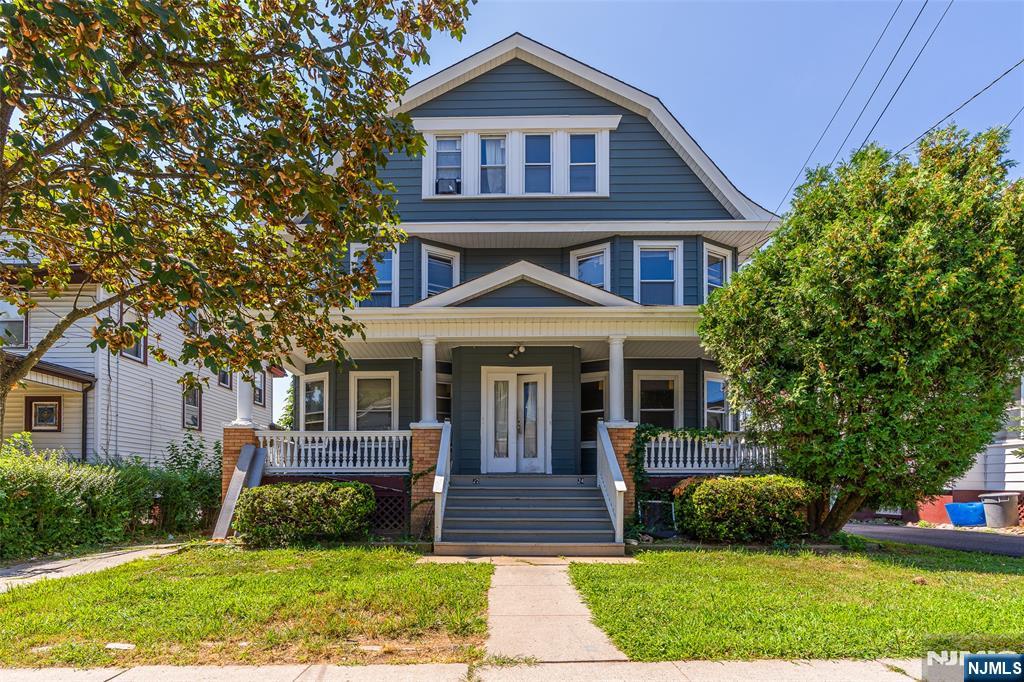 24 Swaine Place, Unit 22 West Orange, NJ 07052 - Photo 12 of 27 a front view of a house with a yard