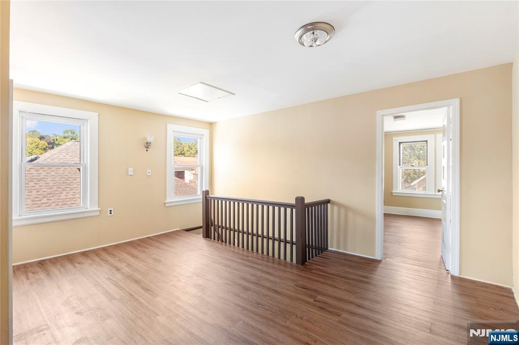 24 Swaine Place, Unit 22 West Orange, NJ 07052 - Photo 14 of 27 an empty room with wooden floor and windows