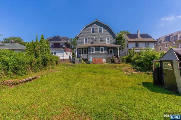 a front view of a house with a big yard