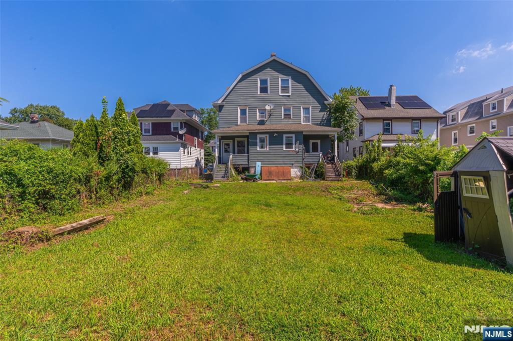 24 Swaine Place, Unit 22 West Orange, NJ 07052 - Photo 16 of 27 a front view of a house with a big yard