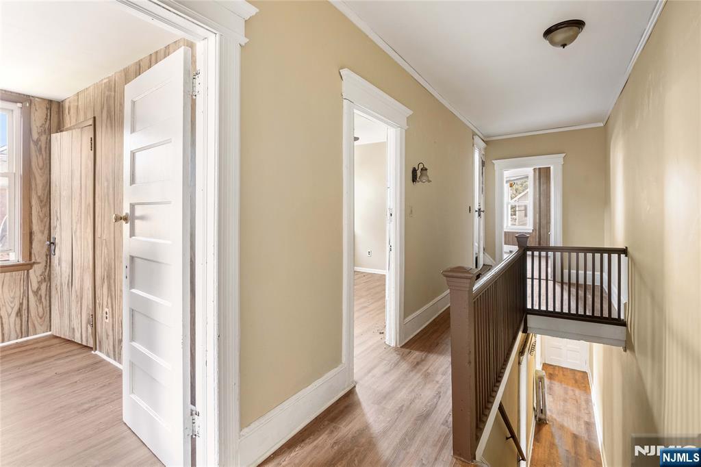 24 Swaine Place, Unit 22 West Orange, NJ 07052 - Photo 22 of 27 a view of a hallway with wooden floor and windows