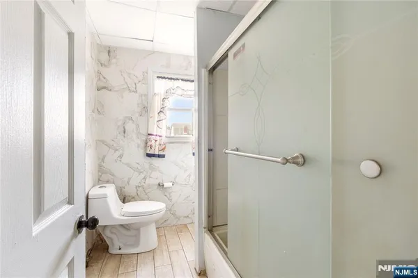 a white toilet sitting next to a bathroom sink