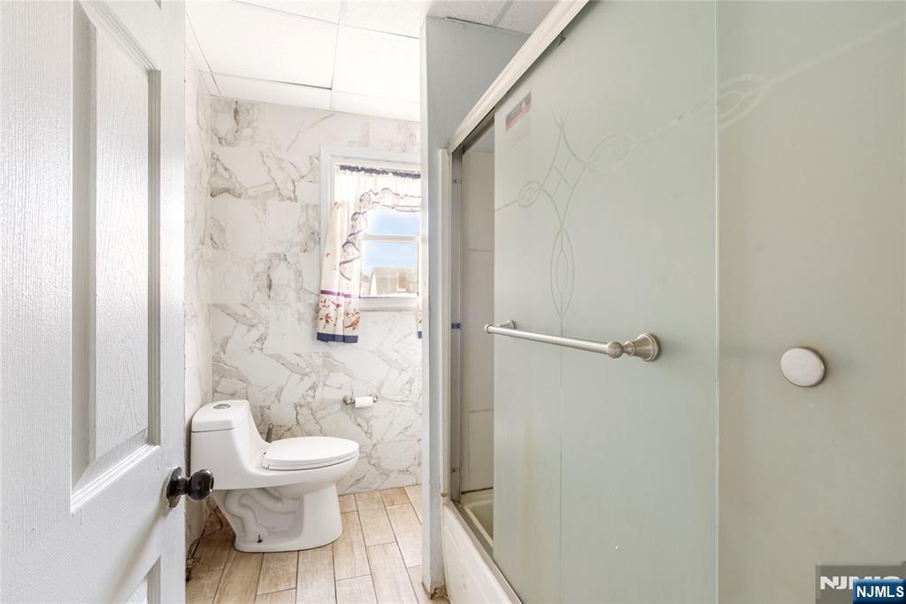 24 Swaine Place, Unit 22 West Orange, NJ 07052 - Photo 23 of 27 a white toilet sitting next to a bathroom sink