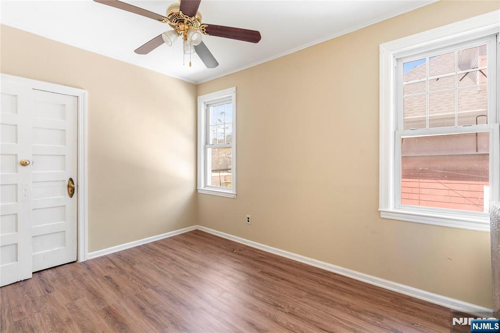 24 Swaine Place, Unit 22 West Orange, NJ 07052 - Photo 27 of 27 wooden floor in an empty room with a window