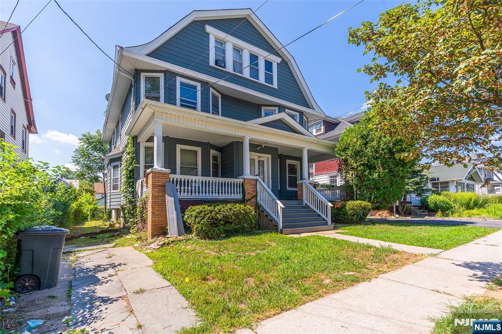 24 Swaine Place, Unit 22 West Orange, NJ 07052 - Photo 3 of 27 a front view of a house with a yard