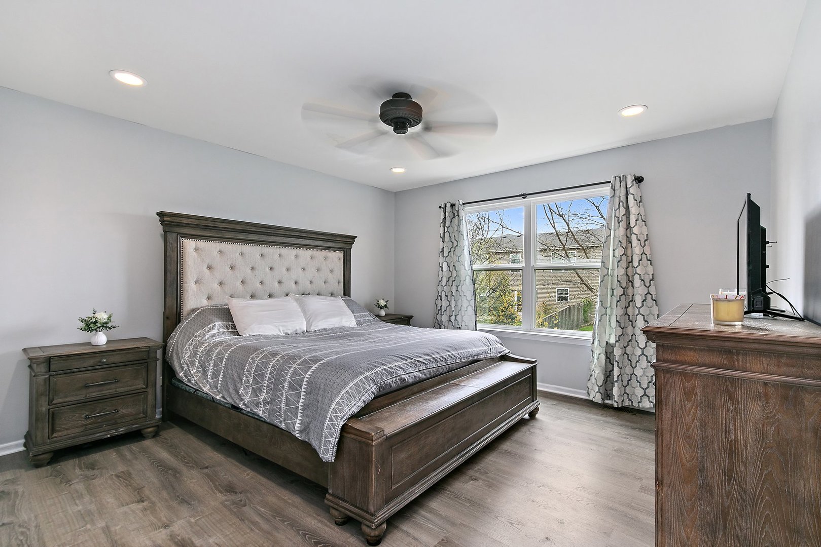 23 Boathouse Road Pingree Grove, IL 60140 - Photo 16 of 25 a bedroom with a large bed and a flat tv screen on dresser