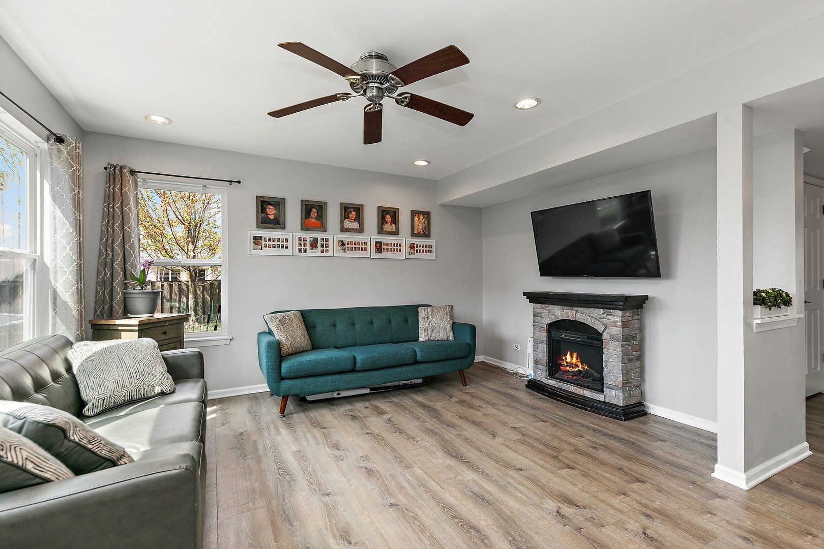 23 Boathouse Road Pingree Grove, IL 60140 - Photo 6 of 25 a living room with furniture a flat screen tv and a fireplace