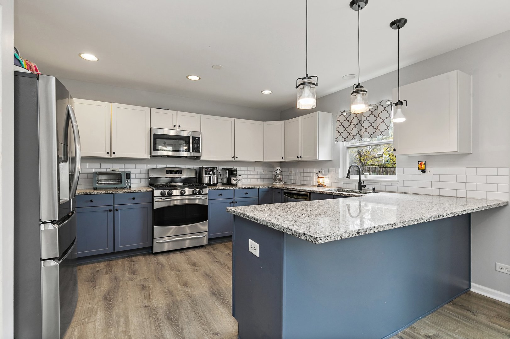 23 Boathouse Road Pingree Grove, IL 60140 - Photo 10 of 25 a kitchen with stainless steel appliances granite countertop a sink a stove a refrigerator cabinets and a kitchen island